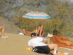 Daring masturbation on a crowdy beach